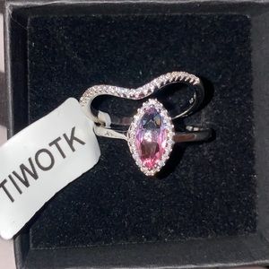 Charmed aroma blue,pink ombre silver ring, that comes w/ a band of white stones.